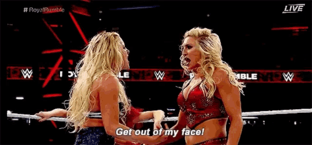 two women are standing next to each other in a wrestling ring and one of them is saying `` get out of my face ! ''
