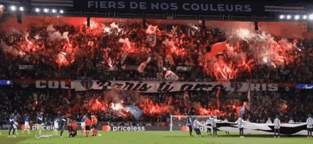 a soccer field with a banner that says " fiers de nos couleurs "