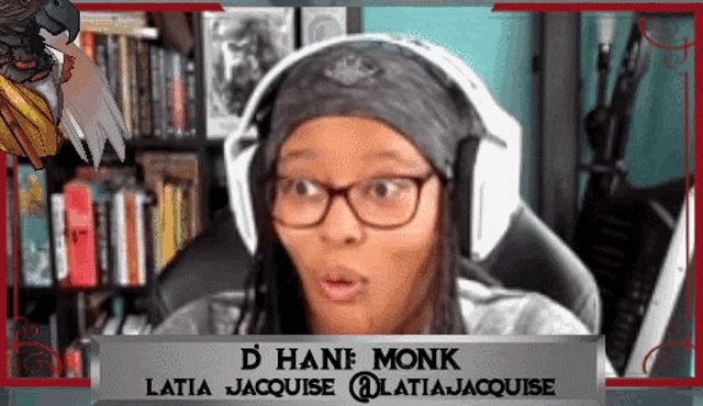 a woman wearing glasses and headphones has the name monk on her sign