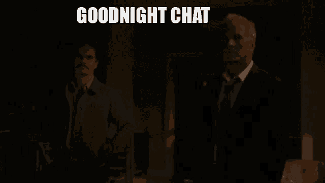 two men are standing in a dark room with the words goodnight chat written above them