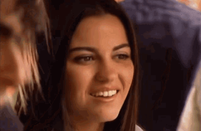 a close up of a woman 's face with a smile on it