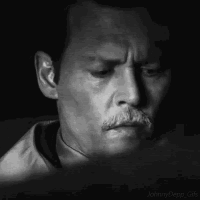 a close up of a man 's face with a mustache .