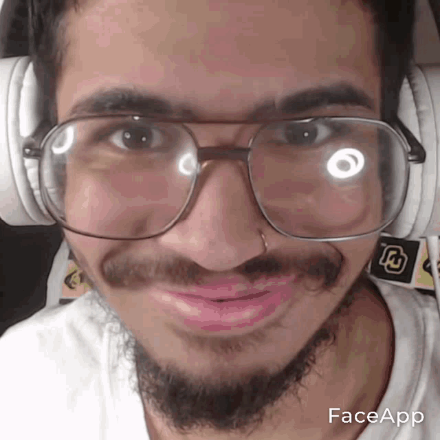 a man with a beard wearing glasses and headphones has faceapp written on the bottom right