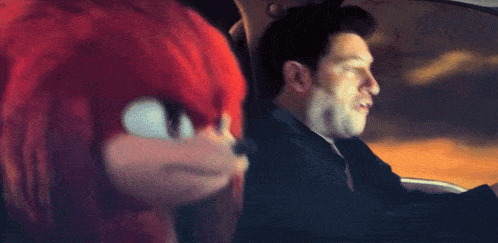 a man is driving a car next to a cartoon character