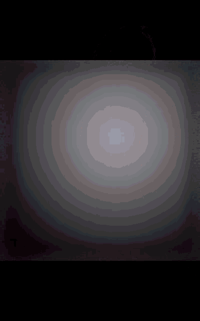 a black background with a gray circle in the middle
