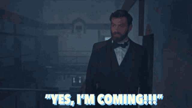 a man in a tuxedo says " yes i 'm coming !!! "