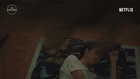 a woman laying on a man 's lap with a netflix logo in the background