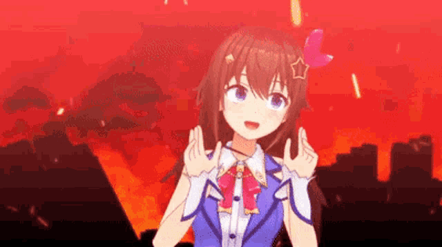 a girl is making a peace sign with her hands in front of a burning city .
