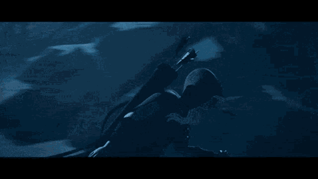 a person is jumping in the air in a snowy forest at night