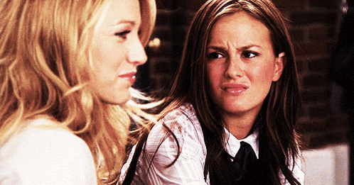 two women are looking at each other and one is making a face