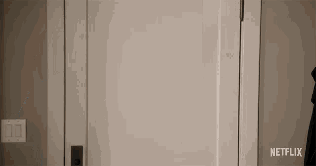 a netflix logo can be seen on a door