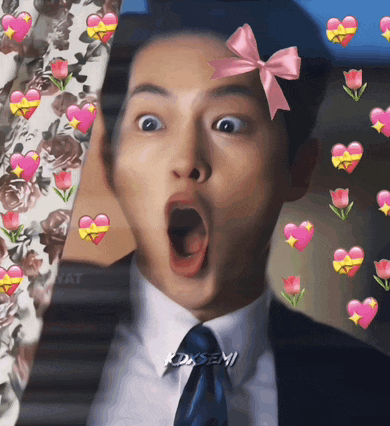 a man in a suit and tie with a pink bow on his head is surrounded by hearts