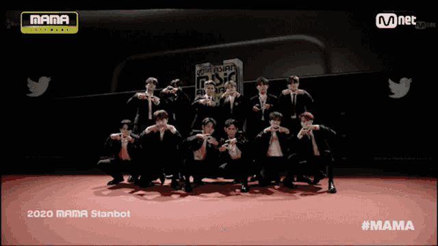 a group of men are posing for a photo on a red carpet for the mama awards