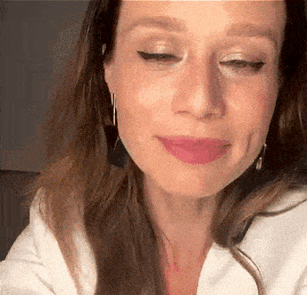 a close up of a woman 's face with her eyes closed and her mouth open .