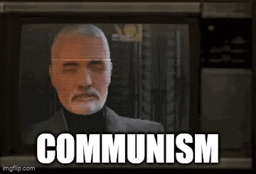 a man with a beard is on a tv screen with the word communism written below him