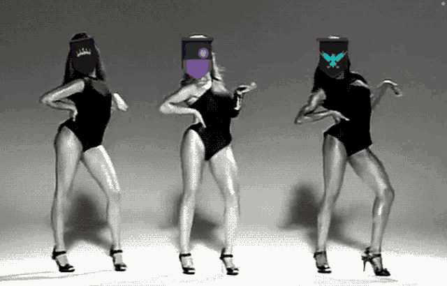 three women in black swimsuits are dancing with masks on