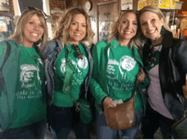 a group of women wearing green shirts that say take it to the chief