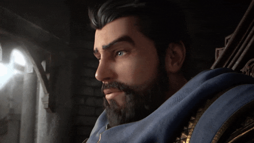 a man with a beard is wearing a blue sweater