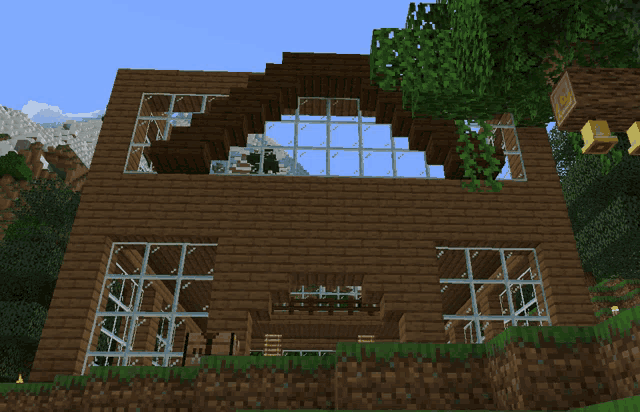 a minecraft house with a lot of windows and a few trees in the background