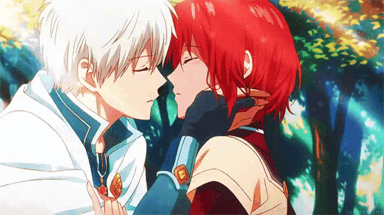 a boy and a girl are kissing in a forest . the girl has red hair and the boy has white hair .