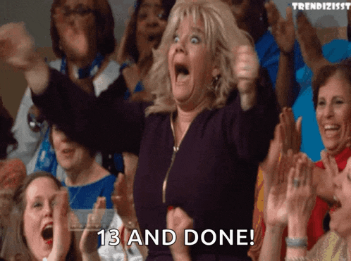 a woman in a crowd holds her fist up in the air and says 13 and done