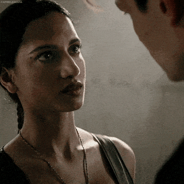 a close up of a woman looking at a man with the caption capricornata