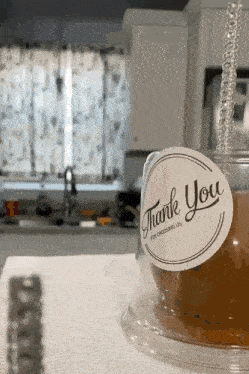 a cup of tea with a thank you tag on it