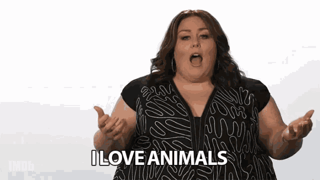 a woman in a black dress says i love animals with her mouth open