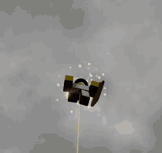 a black object with a halo on top of it is floating in the air