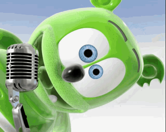 a green gummy bear with blue eyes is singing into a silver microphone