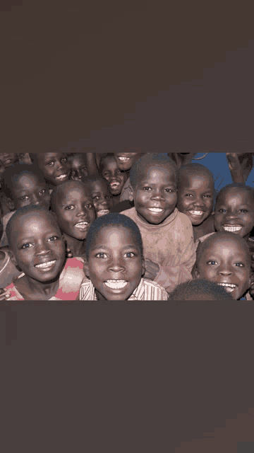 a group of children are smiling for a picture