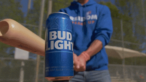 a man in a blue shirt is swinging a bat