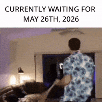 a man in a floral shirt is standing in a living room .