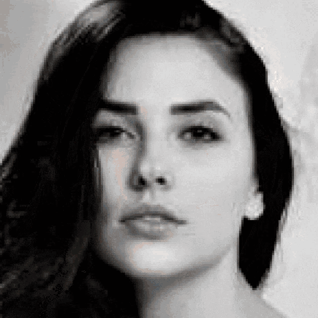 it is a black and white photo of a woman 's face .