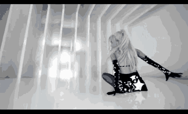 a woman in a black and white dress with stars on it