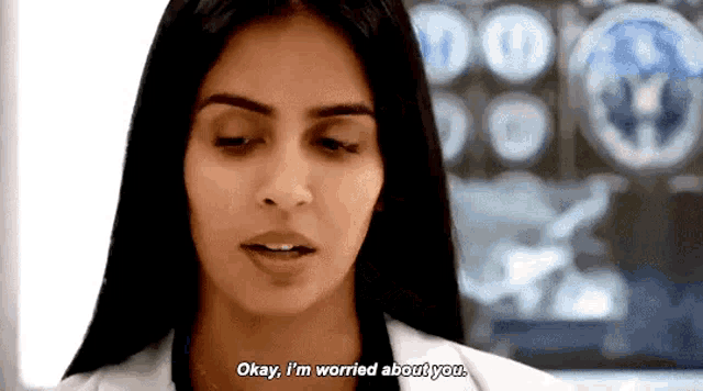 a woman in a lab coat is talking to another woman and says okay , i 'm worried about you .