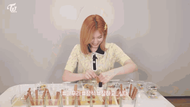 a woman is making a candle with cinnamon sticks and a candle holder .