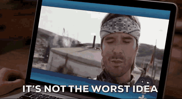 a man with a bandana on his head is on a laptop screen with the words it 's not the worst idea