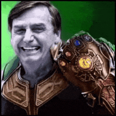 a man is wearing a superhero costume and holding a infinity gauntlet .