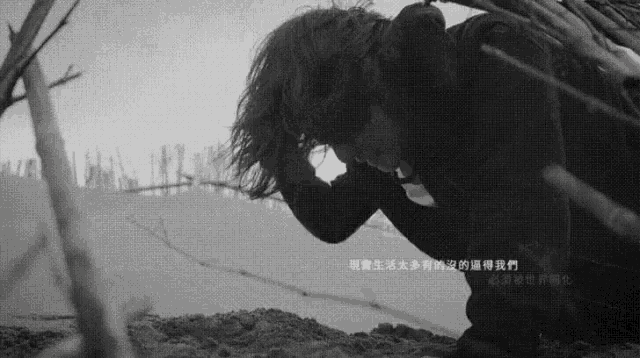 a black and white photo of a person kneeling down