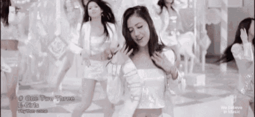 a group of women are dancing in a video for one two three by e-girls