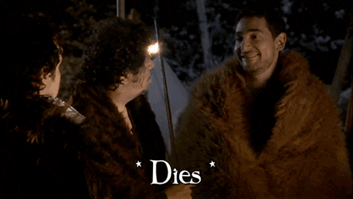 a man in a fur coat talks to another man with the word dies above him