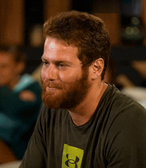 a man with a beard is wearing a green under armour shirt