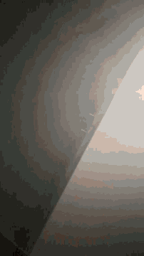 a dark room with a light coming from the corner