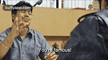 a man is talking to another man and saying `` you 're famous ! ''