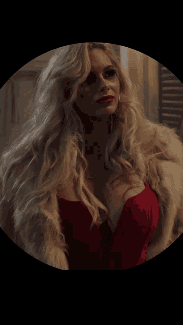 a woman in a red dress and fur coat