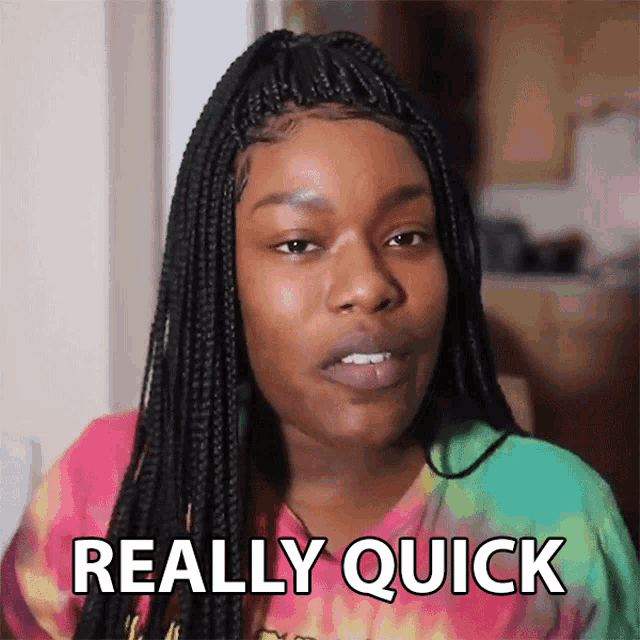 a woman with braids says " really quick " in front of her face