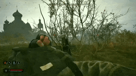 a person is holding a gun in a video game while standing in a field with trees and a church in the background .