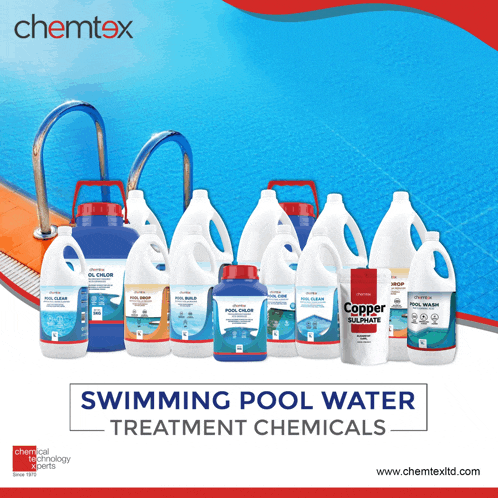 bottles of swimming pool water treatment chemicals lined up in front of a swimming pool