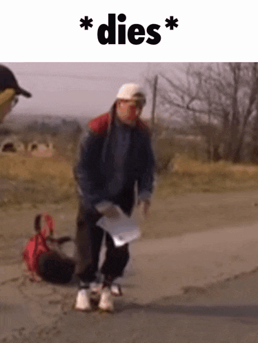 a man is walking down a road holding a piece of paper and a bag .